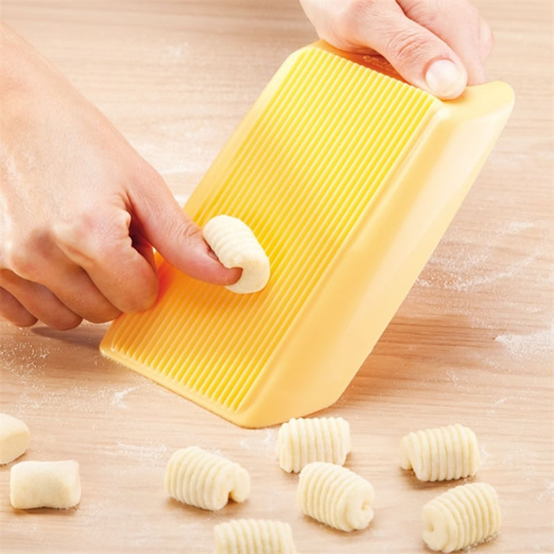 https://thekitchenessence.com/cdn/shop/products/Plastic-Pasta-Machine-Macaroni-Board-Spaghetti-Pasta-Gnocchi-Maker-Cutter-Rolling-Pin-Kitchen-Tool-Baby-Food.jpg?v=1625569063
